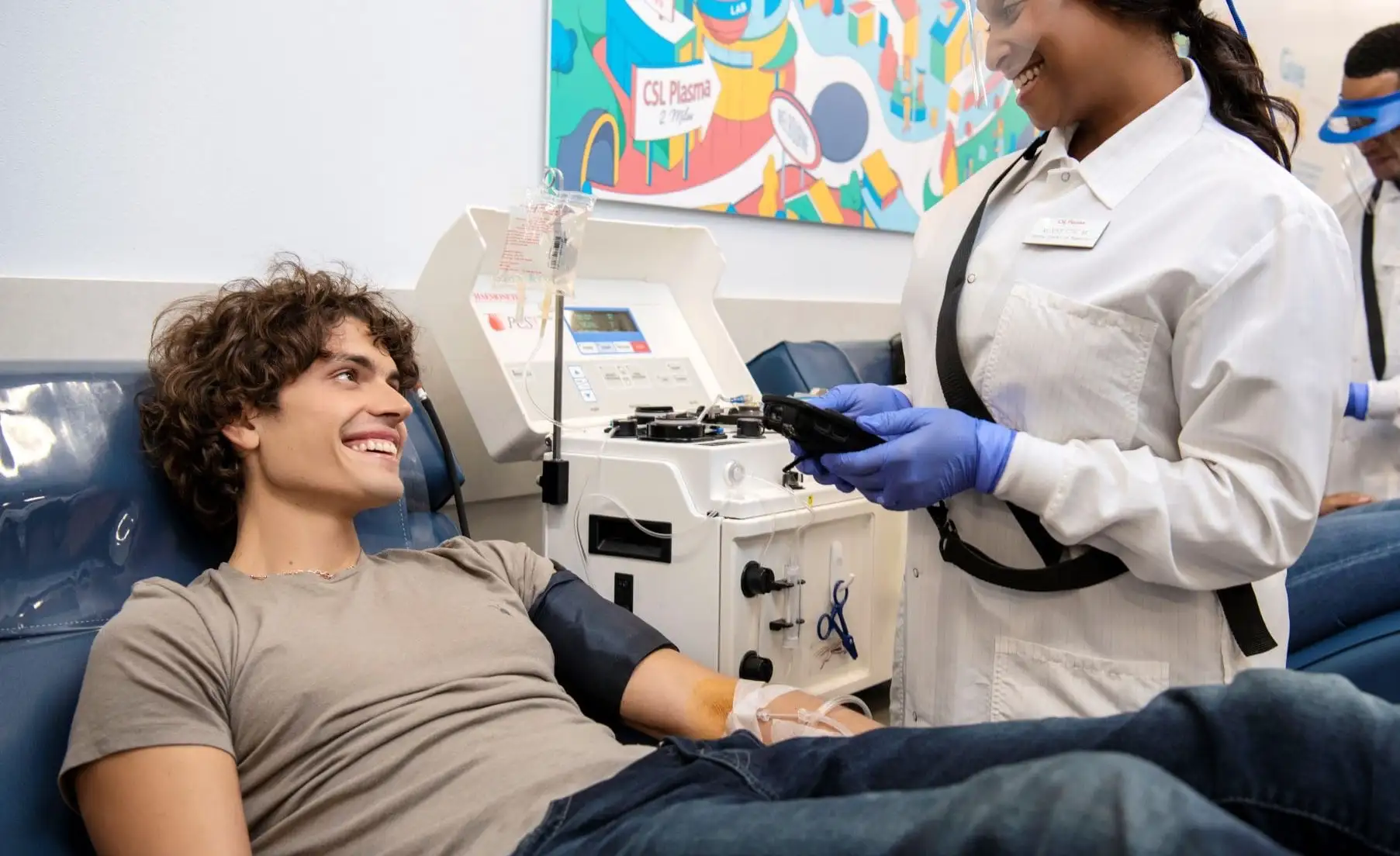 a young adult male patient donating plasma