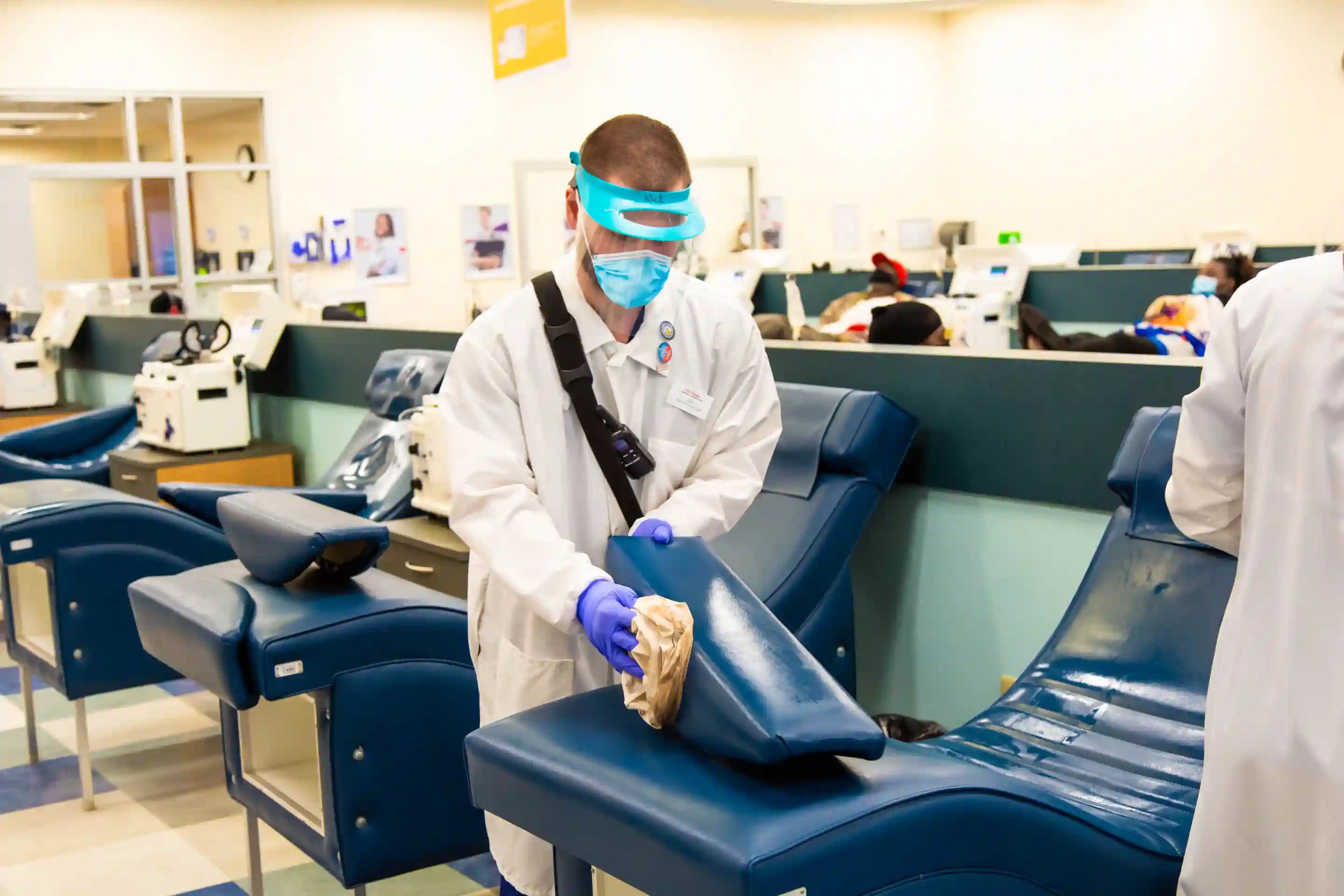 CSL Plasma employee cleaning donation bed