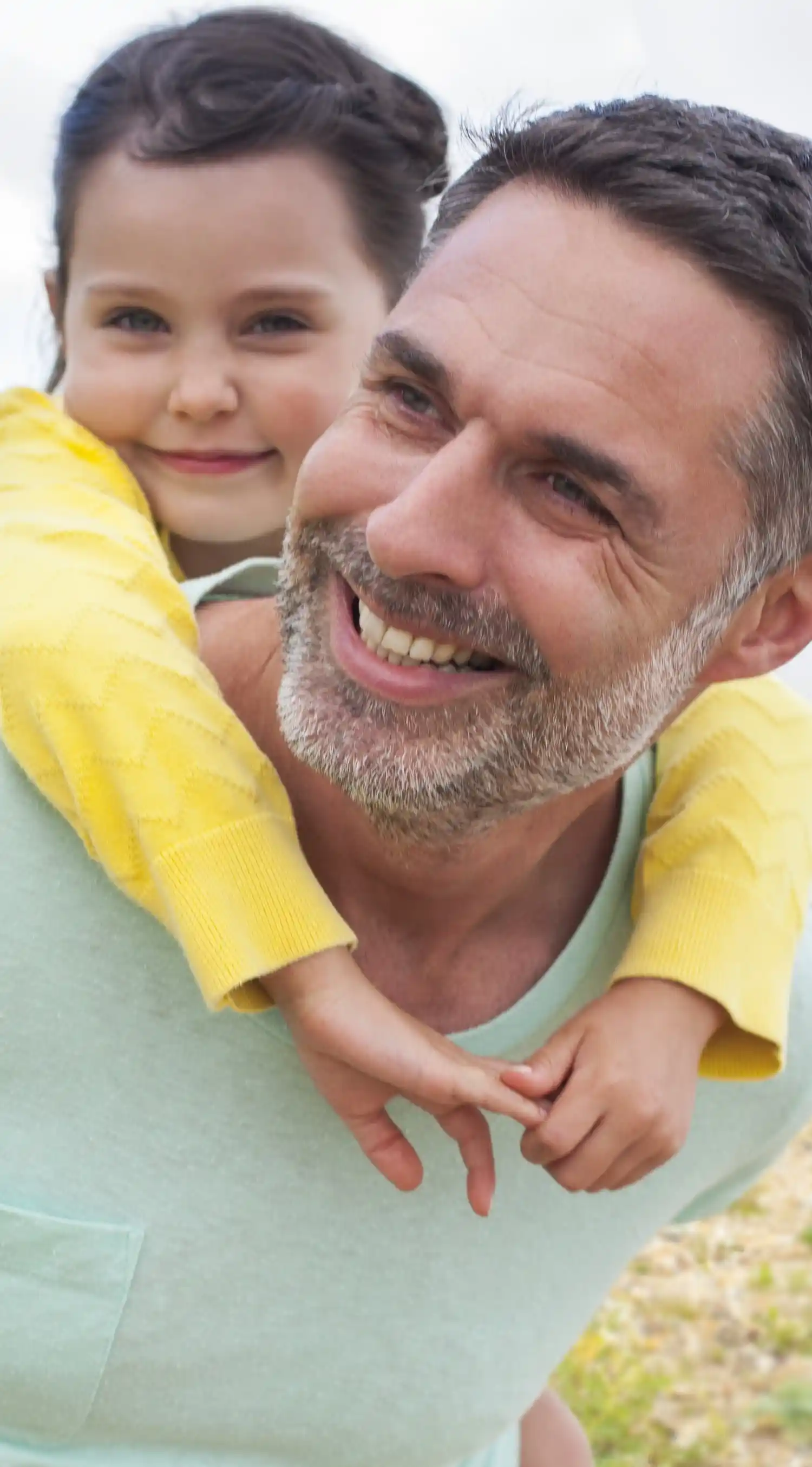 Happy father and daughter in a piggy back ride